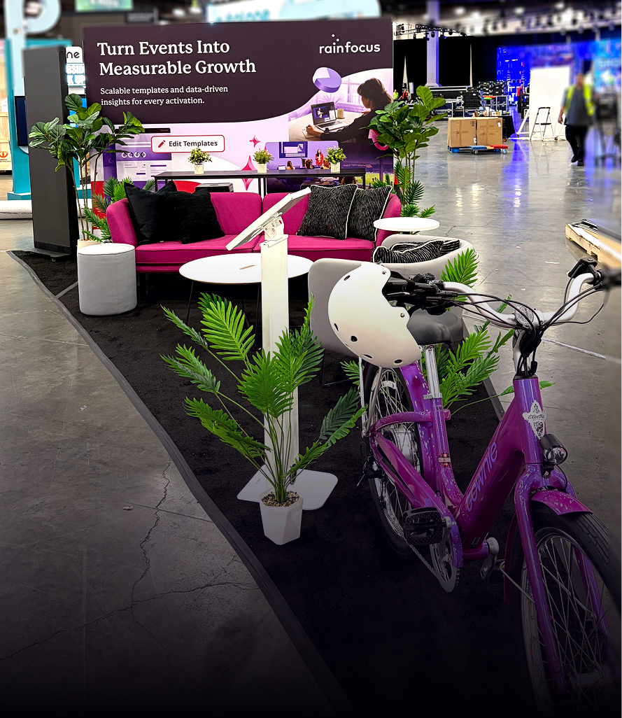 Modern exhibition booth with lounge seating and branded bicycles